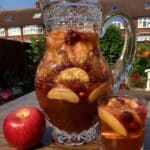 Apple Cider Sangria 7 Apple cider sangria in a clear pitcher with fall fruit