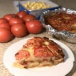 Crustless Tomato Pie 7 Crustless tomato pie on a white plate with golden cheese