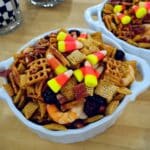 crisp leaves crunching 7 Fall snack mixes in a wooden harvest bowl with candy corn and pretzels