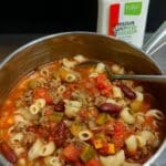 Pasta Fagioli Soup Recipe (Barefoot Contessa Style) 7 Pasta fagioli soup in white bowl with Parmesan topping