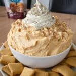 Pumpkin Fluff Dip 7 Pumpkin fluff dip in white bowl with apple slices on wood tray