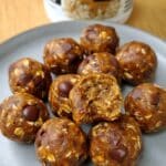 Pumpkin Spice Protein Balls 7 Pumpkin Spice Protein Balls on rustic plate with oats and maple drizzle