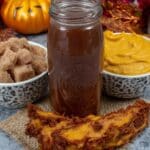 Pumpkin Spice Syrup 7 Jar of pumpkin spice syrup with cinnamon sticks on wood table