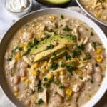 White Chili Chicken Recipe 7 White chili chicken recipe in a cream-colored soup bowl with cilantro garnish