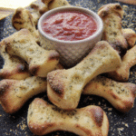 Cheesy Halloween Breadstick Bones on a parchment-lined baking sheet.