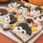 A close-up of Chocolate Halloween Oreo Bark with festive sprinkles and candy eyeballs.