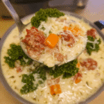Creamy Sweet Potato and Sausage Soup 7 Creamy Sweet Potato and Sausage Soup in a bowl, garnished with fresh herbs.