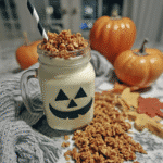 Halloween Overnight Oats 7 A jar of pumpkin spice overnight oats topped with granola and chopped pecans.