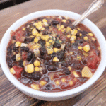 Instant Pot Vegan Black Bean Soup 7 A hearty bowl of Instant Pot Vegan Black Bean Soup, garnished with fresh cilantro.