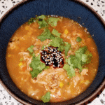 Lemon Chicken Orzo Soup 7 A steaming bowl of Lemon Chicken Orzo Soup, garnished with fresh parsley and lemon zest.