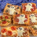 Ingredients for Mini Halloween Pizzas laid out on a table.