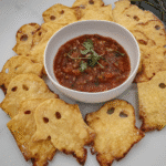 Spooky Baked Halloween Chips on a plate with guacamole