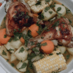 A steaming bowl of Sancocho, garnished with fresh cilantro.
