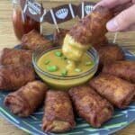 Buffalo Chicken Egg Rolls 7 Buffalo chicken egg rolls on white platter with dipping sauce