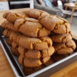 Pumpkin sugar cookies fresh from the oven on parchment-lined tray