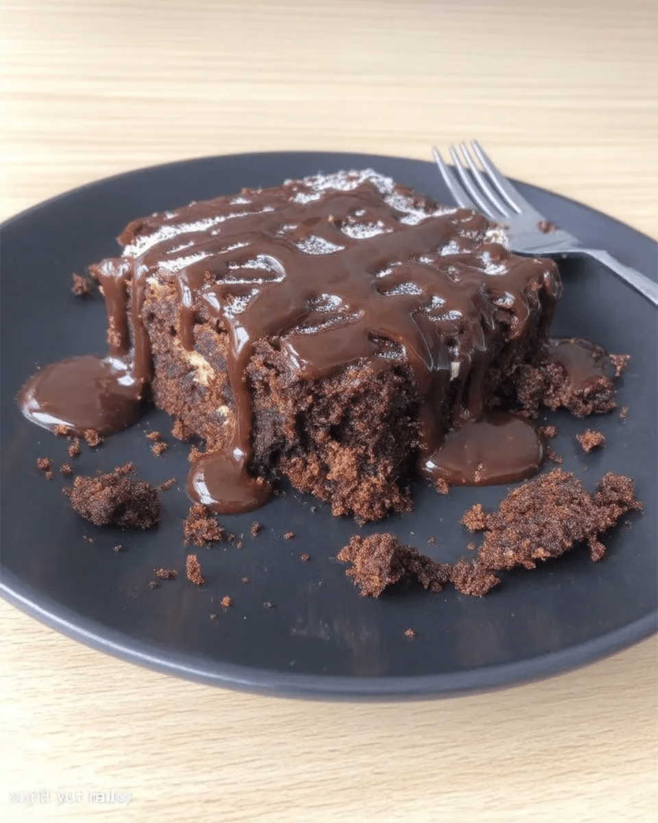 No-Bake Caramel Brownies 9 A hand holding a perfectly cut no-bake caramel brownie.