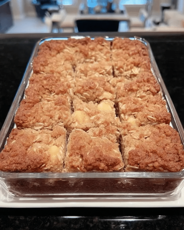 Apple Cinnamon Oatmeal Bars 8 A flat lay of the ingredients needed to make apple cinnamon oatmeal bars, arranged on a rustic wooden table.