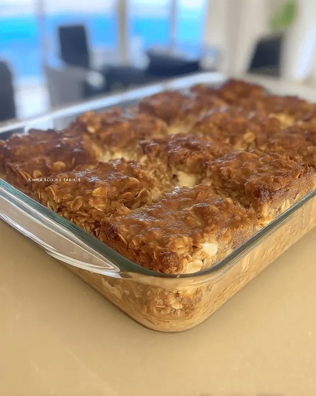 Apple Cinnamon Oatmeal Bars 9 A process shot of folding chopped apples into oatmeal bar batter, demonstrating a key step in the recipe.