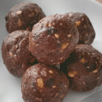 Brownie bliss balls stored in a glass jar for easy snacking.