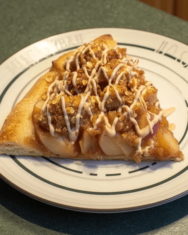 Caramel Apple Pizza 10 A slice of Caramel Apple Pizza served with a scoop of vanilla ice cream.