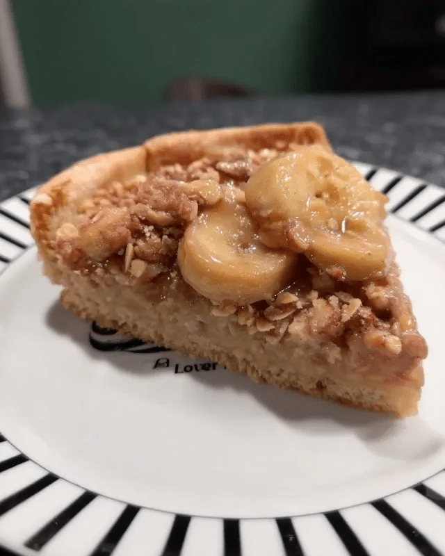 Caramel Apple Pizza 9 A close-up shot of the vegan caramel sauce being drizzled over a slice of apple pizza.