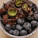 Close-up of dark chocolate covered blueberries on a plate.