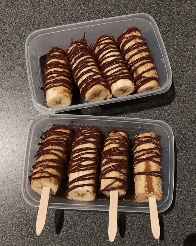 Frozen Chocolate Covered Banana Pops 10 A platter of Frozen Chocolate Covered Banana Pops served with other frozen treats, such as fruit skewers and small ice cream cones.