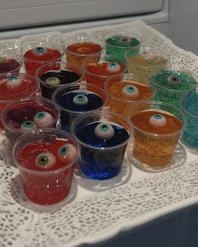 Halloween Eyeball Jello Shots 10 Halloween Eyeball Jello Shots served with other Halloween treats.