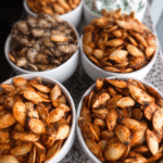 A close-up shot of roasted pumpkin seeds seasoned with various spices, showcasing their crispy texture and warm colors.