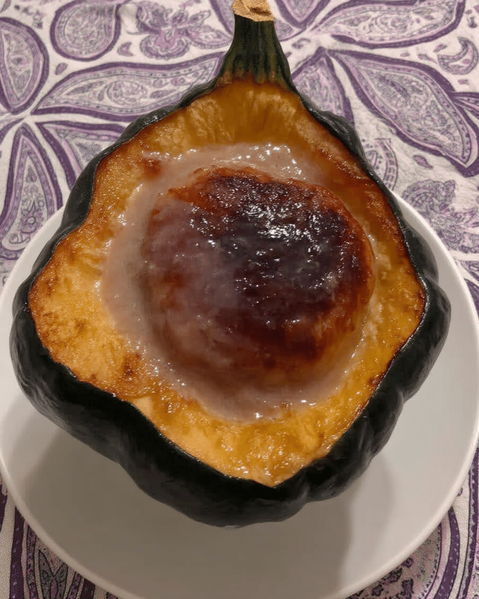 Roasted Acorn Squash 10 Roasted acorn squash served on a plate, garnished with fresh herbs.