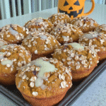 Close-up of a Starbucks Pumpkin Cream Cheese Muffin, showing the moist crumb and creamy swirl.