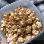 White Chocolate Peanut and Butter Popcorn 7 White Chocolate & Peanut Butter Popcorn served in bowls with a scoop of ice cream.
