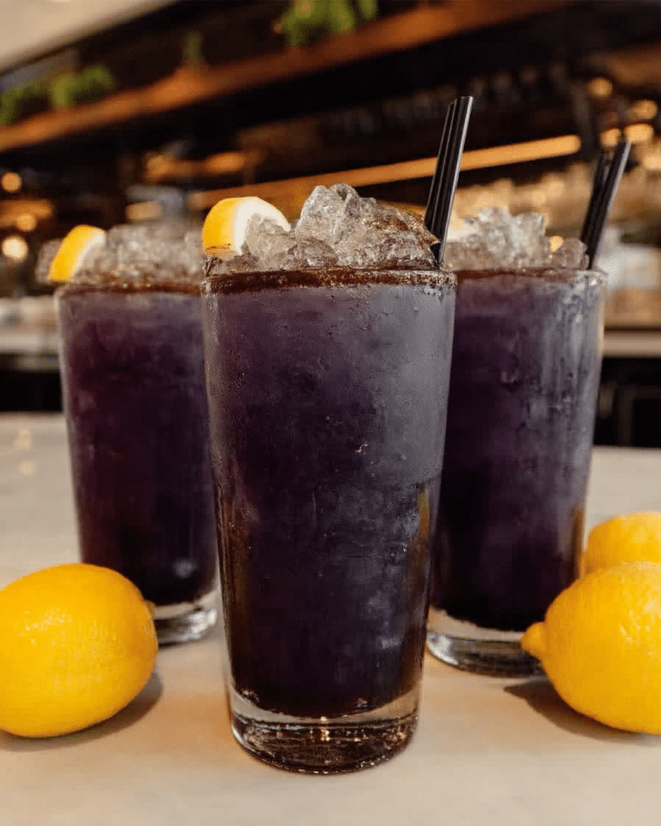 Witches Brew Lemonade 9 Garnishing Witches Brew Lemonade with lemon slices and gummy worms.