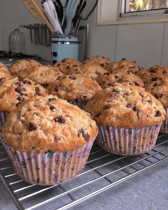 Paleo Pumpkin Chocolate Chip Muffins 9 Freshly baked paleo pumpkin chocolate chip muffins cooling on a wire rack.